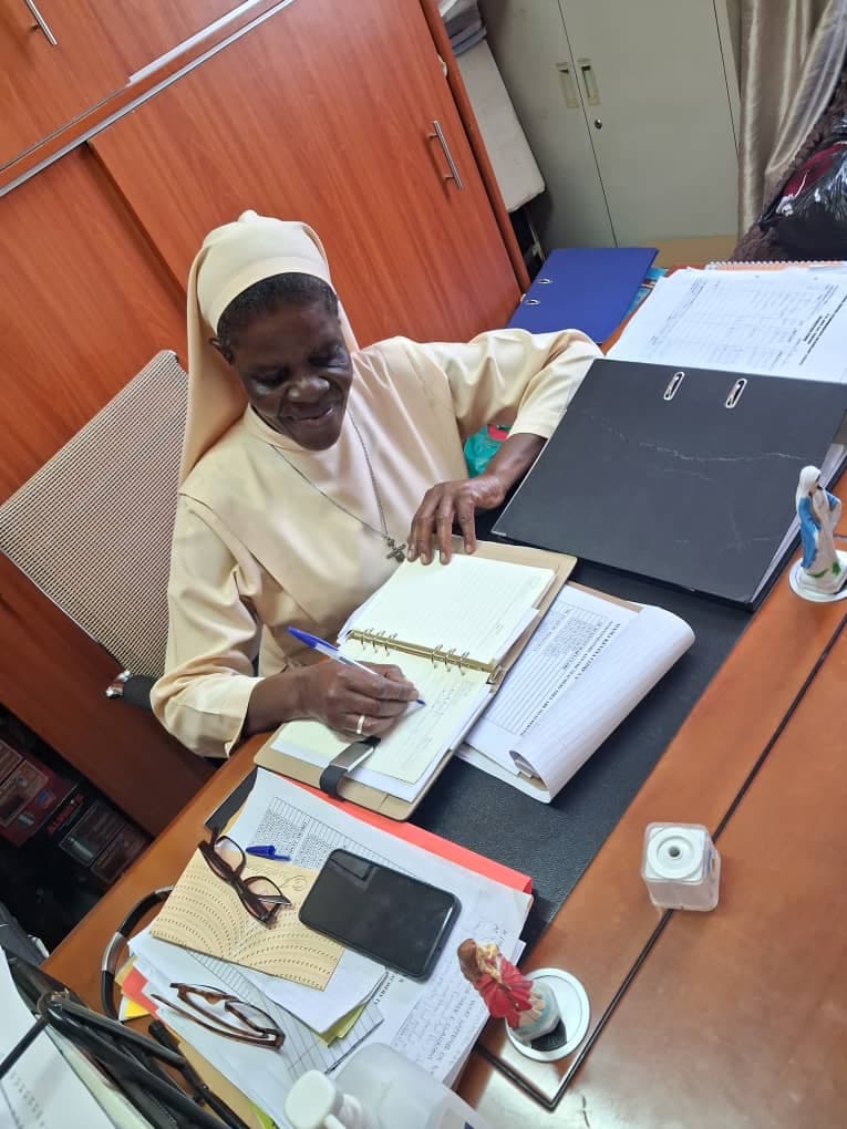 Mama Kevina working at her office desk